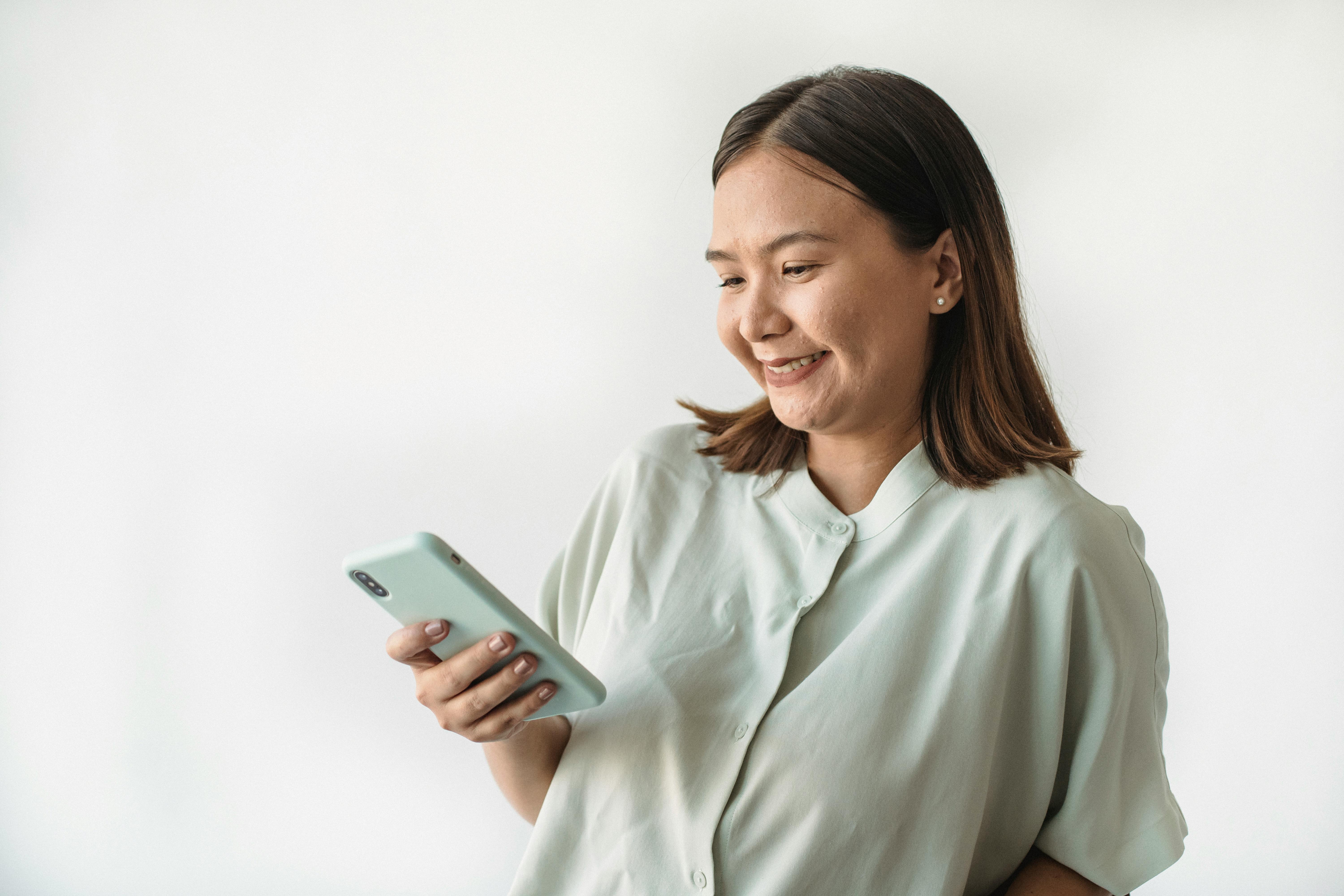 Person smiling at phone